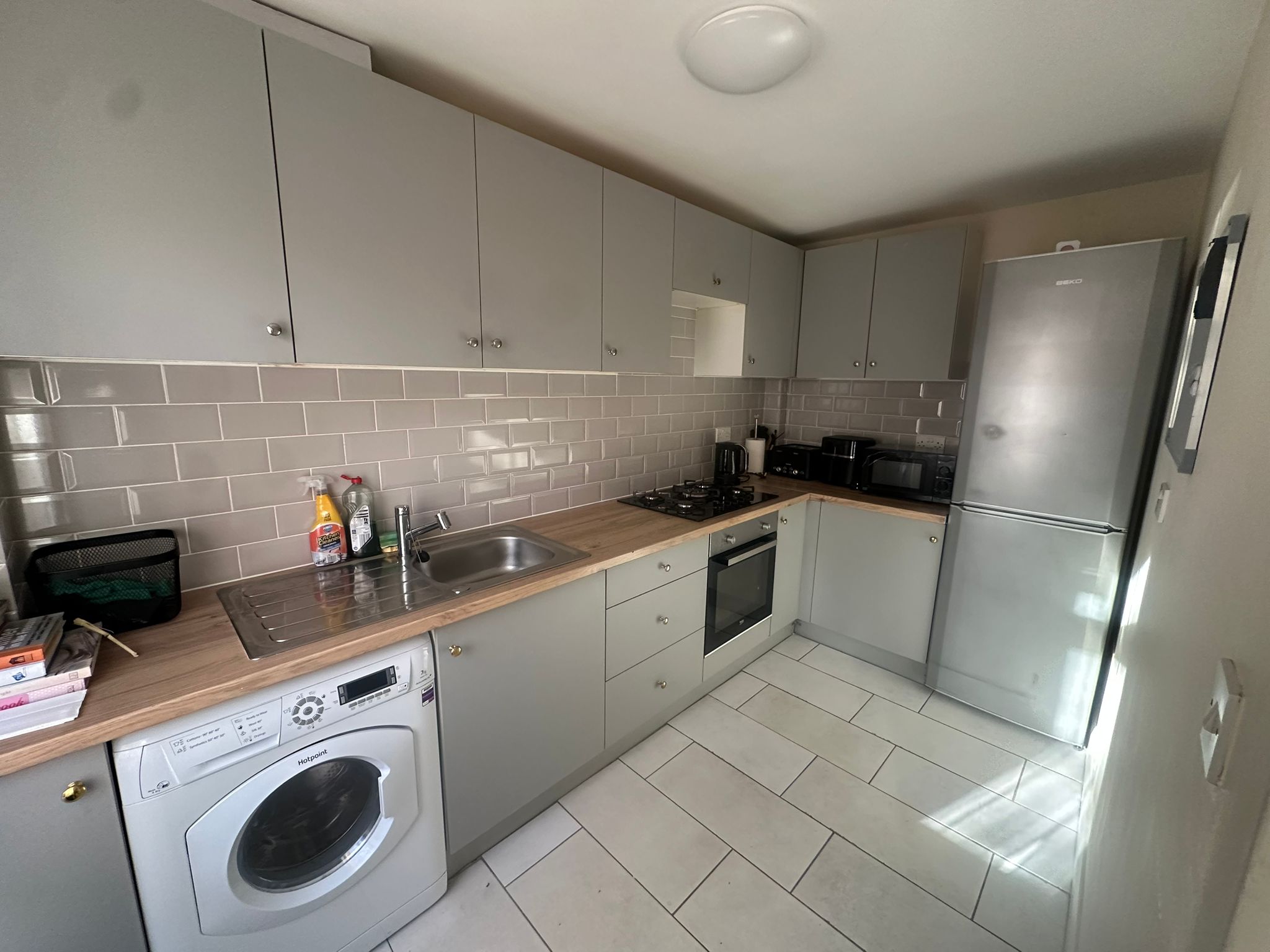 Gannett House modern kitchen with grey cabinets and full appliances