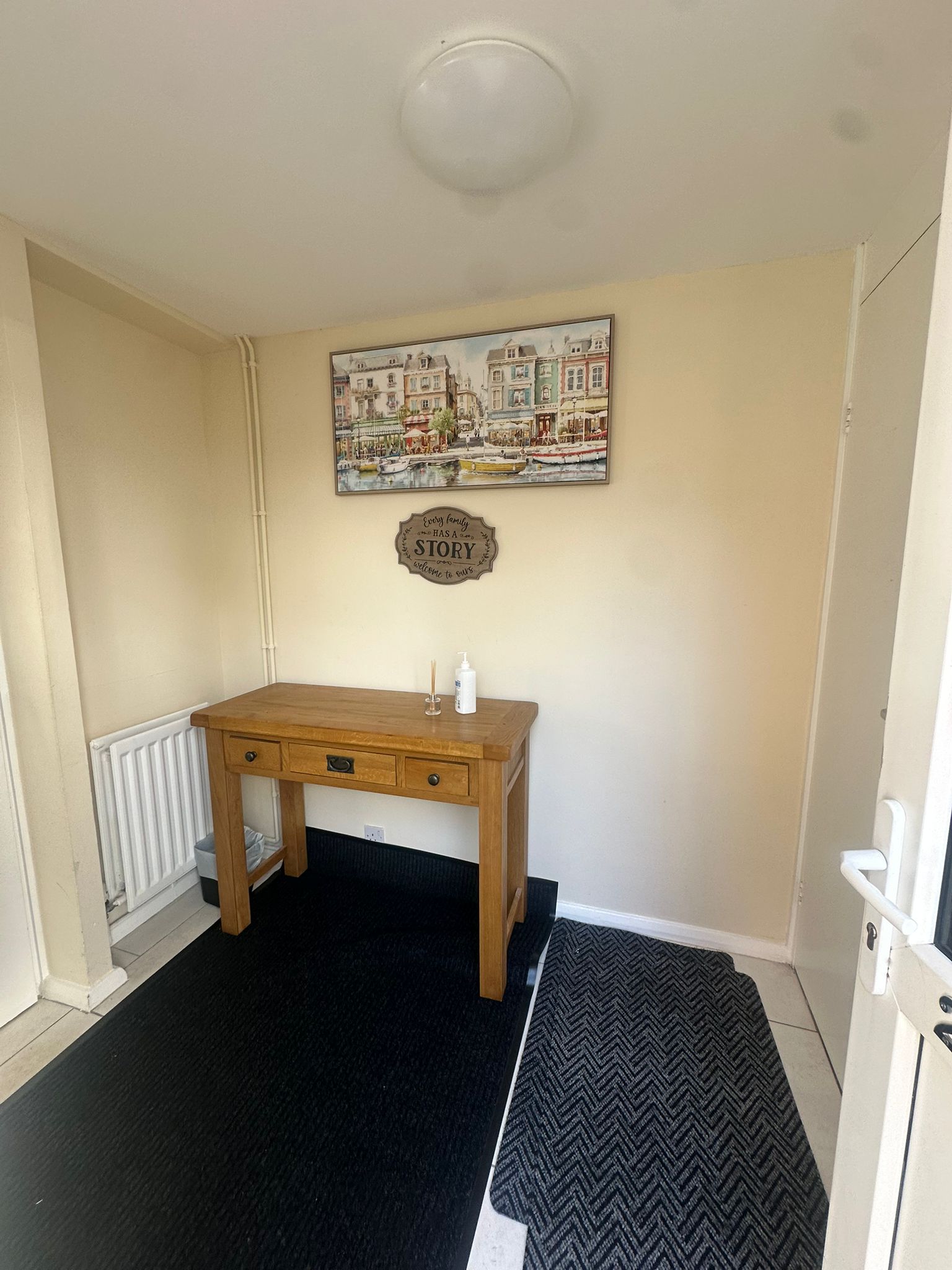 Gannett House entrance hallway with console table and welcome sign