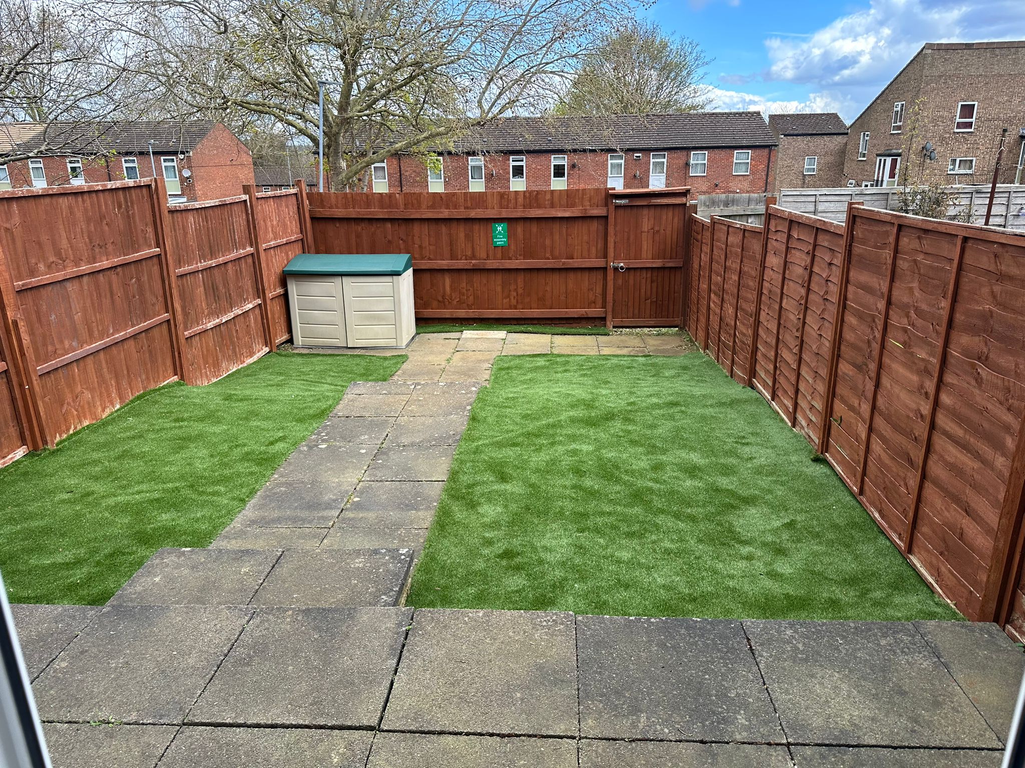 Gannett House rear garden with artificial grass and stone pathway